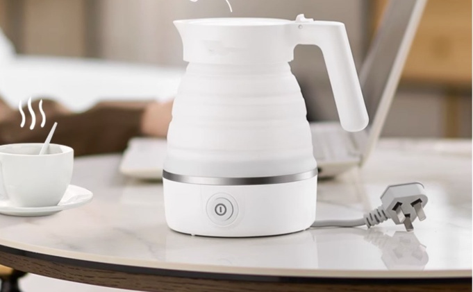 Unplugged white travel kettle on table